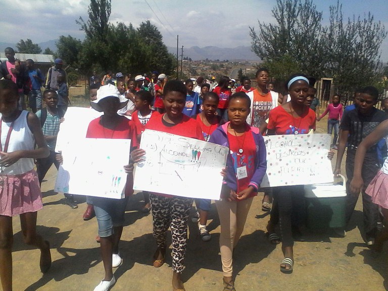 Rise members leading the march and holding posters, Buddies were also part of the march and the community were part of solution too