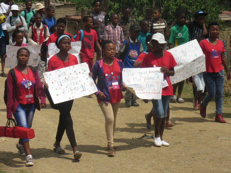 Rise members leading the march and holding posters, Buddies were also part of the march and the community were part of solution too