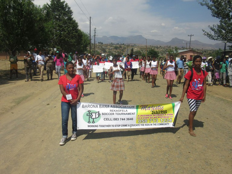 Rise members leading the march and holding posters