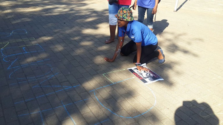 Aids Day slogons on pavement in front of hospital